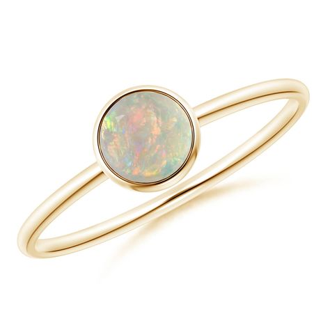 Simple yet elegant, this classic solitaire opal ring is sure to fascinate. The cabochon opal, secured in a bezel setting, allures with its delightful color play. This 14k yellow gold round opal ring has a sleek shank that adds to its effortless beauty. Solitaire Opal Ring, Opal Stone Ring, Opal Solitaire Ring, Effortless Beauty, Contemporary Ring, Color Play, Opal Stone, Stackable Ring, Opal Ring