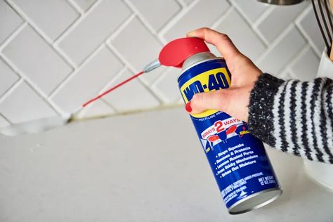 9 Surprising Uses for a Can of WD-40 | Apartment Therapy Oil Out Of Clothes, Gardening Tool Handles, Squeaky Door Hinges, Wd 40 Uses, Remove Sticky Residue, Squeaky Door, Remove Oil Stains, Cleaning Tips Tricks, Diy Cleaning Hacks