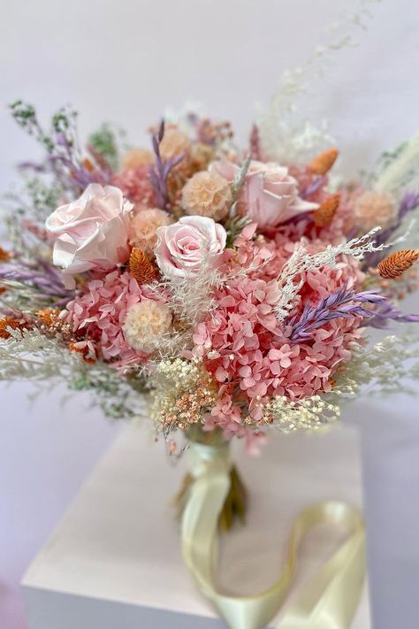 Pretty pink preserved flower bridal bouquet with pops of purple and orange tied with cream ribbon Horseshoe Flowers, Preserved Wedding Flowers, Pastel Bridal Bouquet, Dried Flower Bouquet Wedding, Flower Boquet, Pastel Bouquet, Dried Flowers Wedding, Flowers For Wedding, Wedding Bouquets Pink