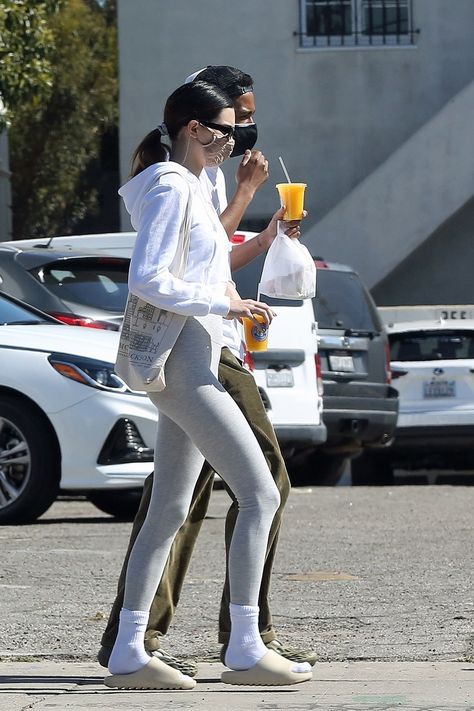 Kendall Jenner was photographed in Los Angeles wearing a White Crystal Hoodie from Brandy Melville, Bone Slide from Yeezy ($286) and Black Preston Rectangular Sunglasses from DMY BY DMY. To shop this look or buy this outfit on a budget, click the theninesfashion.com link. #KendallJenner #LosAngeles #TheKardashians #BrandyMelville #Yeezy #DMYBYDMY Kendall Jenner Yeezy Slides, Outfit With Yeezy Slides, Yeezy Slide Bone Outfit, Slides With Socks Outfit, Yeezy Slides Outfit, Skims Outfit, 2023 Vibes, Slides Outfits, Kanye West Adidas