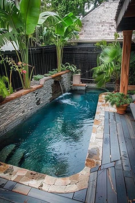 A cozy backyard pool with a stone wall featuring a water fountain, surrounded by lush tropical plants and wooden decking. Soak Pool, House Pools, Tiny Pool, Raised Pools, Small Backyard Pool Ideas, Small Backyard Pool, Backyard Pool Ideas, Backyard Layout, Backyard Designs