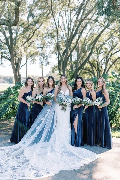 Orlando Wedding Planner - Plan It Events | Captured by Matlock & Kelly Photography | www.planitcfl.com/blog | blue velvet bridesmaids dresses | long bridal veil Blue Wedding Theme Winter, Wedding Blue Aesthetic, Dark Blue Wedding Aesthetic, Christmas Wedding Blue, Blue Christmas Wedding Theme, Royal Blue Winter Bridesmaid Dresses, Dark Navy Blue Wedding, Midnight Blue Bridesmaid, Dark Blue Wedding Colors