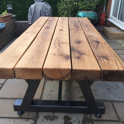 Photo by Peter C. Here is how Peter created with fantastic table with our sleepers: 
“Heavy duty patio table that I made using the 100x200x2400 oak sleepers I purchased from your company. I fabricated the frame from 100x100 steel box section steel, fully welded and strengthened & then had it powder coated graphite grey. The sleepers are fixed to the frame using 8mm stainless steel coach screws. This is probably the most heavy duty patio table available & hopefully it will last for many years.” Sleeper Table Garden, Sleeper Table, Oak Sleepers, Table Garden, Wood Company, Landscape Projects, Patio Table, Pallet Table, Garden Projects