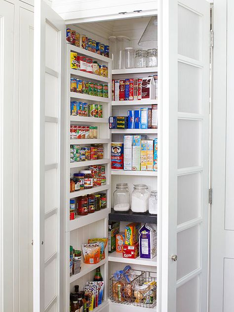 Make the most of a small pantry by outfitting each of the three walls with floor-to-ceiling shelving. Choose deeper, taller shelves for the back wall and short, narrow ledges on each side for cans, bottles, and other pint-size products. Reeded-glass doors hide the pantry's contents but keep the kitchen airy. Installing a pendant light inside the closet makes it easy to grab and go, especially a late-night snack. Vertical Pantry, Melamine Shelves, Shallow Pantry, Walk In Pantry Ideas, Narrow Pantry, Open Pantry, Shallow Shelves, Storage Pantry, Pantry Wall