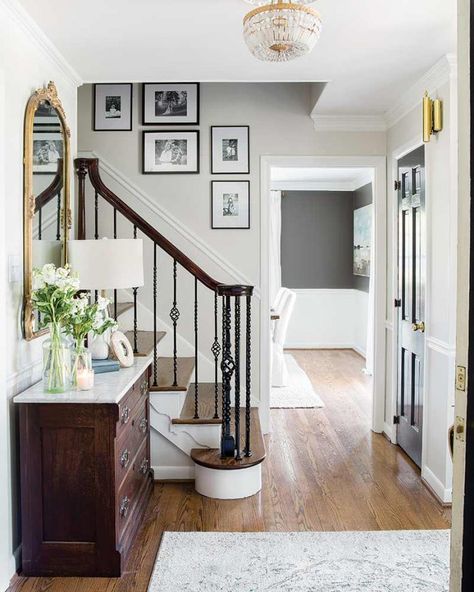 See the Transformation: Brick Colonial Turned Charming Farmhouse - The Cottage Journal Brick Colonial House, Foyer Paint Colors, Stairway Gallery Wall, Black Stair Railing, Colonial House Interior, Ideas Entryway, Black Stairs, Foyer Ideas, Colonial Farmhouse