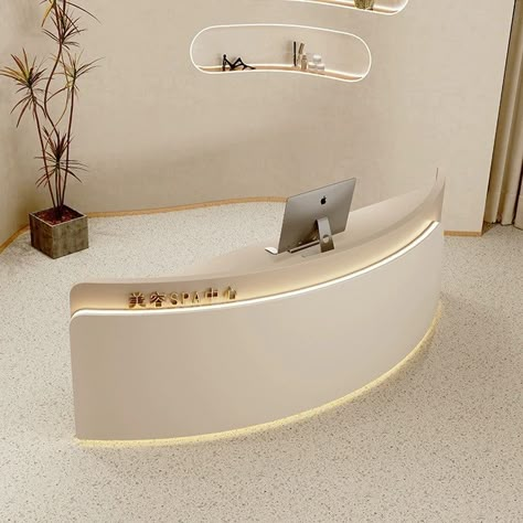 This stylish reception desk combines a minimalist design with a touch of modern elegance, creating a welcoming focal point for your salon space. The semi-circular shape adds a contemporary flair, while the clean lines and subtle curves exude sophistication. Crafted for both functionality and aesthetics, this front desk is ideal for creating a chic and organized reception area that leaves a lasting impression on your clients. Upgrade your salon experience with this versatile and trendy addition. Curved Salon Reception Desk, Curved Desk Design, Minimalist Beauty Room, Beautiful Reception Area, Beauty Salon Interior Design Minimalist, Salon Reception Area Design, Minimalist Reception Design, Modern Front Desk Reception Areas, Spa Reception Area Waiting Rooms