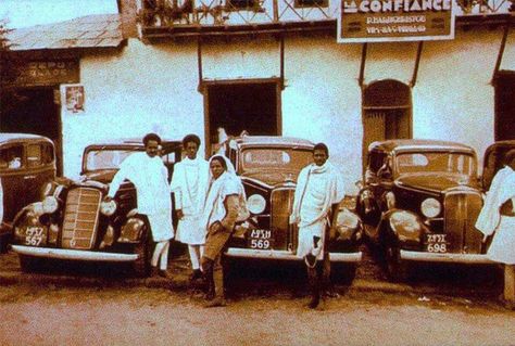 ETHIOPIA’S FIRST TAXI COMPANY Around 1937, about a year and half through the second invasion of Ethiopia by Italy, a taxi company was operating by an Italian businessman named Sighnore Fernondo. The company opened its doors for service around Georgis Church of Arada as seen in the image. At the time, the taxis were dark brown and served only European residents around the city. Ethiopians were not allowed to ride them unless they were bandas or servitore አገልጋይ. My other source, which is The Armen Ethiopia History, Ethiopia Addis Ababa, Ethiopian History, History Of Ethiopia, Ethiopian Culture, Vintage Pics, Addis Ababa, History Pictures, East Africa