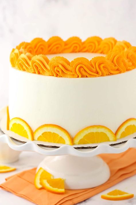 Three layers of fluffy orange cake are drizzled with orange simple syrup and coupled with whipped cream cheese frosting in this tempting dessert! Fresh citrus flavor graces each and every bite of this easy Orange Layer Cake. Orange Cake Ideas, Orange Color Cake, Light Cream Cheese Frosting, Orange Cake Decoration, Orange Flavoured Cake, Summer Cake Ideas, Orange Layer Cake, Orange Birthday Cake, Orange Cakes