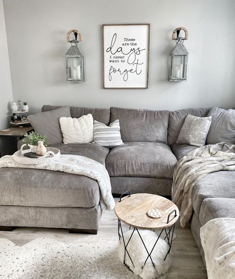 Two gray metal lantern sconces are mounted above a gray sectional sofa with gray throw blankets. A small round wood and black metal cage table is used as a coffee table. Grey Farmhouse Living Room, Modern Farmhouse Living Room Ideas, Grey Sectional Sofa, Modern Farmhouse Living, Grey Sectional, Modern Farmhouse Living Room, Farmhouse Decor Living Room, Decor Home Living Room, Living Room Sectional