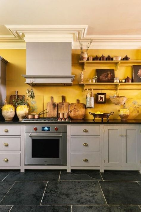 Deep Yellow In this DeVol kitchen, the warm marigold paint is grounded by cool gray cabinets. The floo 1920 Kitchen, Popular Kitchen Colors, 1920s Kitchen, Bungalow Kitchen, Yellow Kitchen Decor, Kabinet Dapur, Yellow Kitchen, Yellow Walls, Kitchen Color