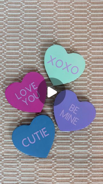 Sam Owen | DIY • Party • Holiday Decor on Instagram: "DIY Conversation Heart Coasters 🩷🩵💚💜 I love candy hearts… but only as decor. Does anyone actually like to eat those?! I made a few mistakes with this, but stil L-O-V-E how they turned out! 💕 I should have lightly sanded the finish to help the paint adhere, but I was being lazy. It still worked ok but I had some issues with the transfer tape peeling off the paint, and I had to re-do a couple. If you try this, I definitely recommend sanding a little! Also, I should have allowed more dry time before applying the decal. I was impatient but also trying to finish during my kid’s nap time 🤣😅 . . . #valentinesday #valentinescraft #diyvalentinesdecor #diyvalentines #cricut #cricutcrafts #candyhearts #conversationhearts #vdaydecor" Diy Large Conversation Hearts, Conversation Hearts Party Decorations, Diy Conversation Hearts Decorations, Conversation Hearts Decorations, Conversation Heart Pillow, Vday Decor, Being Lazy, Conversation Heart, Diy Valentines Decorations