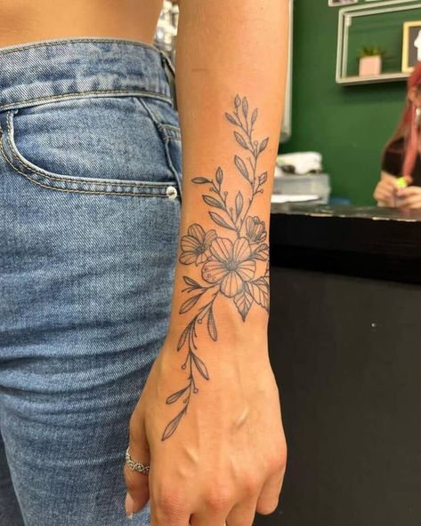 Minimalistic forearm floral tattoo Arm Tattoos For Women Forearm, Floral Tattoo Ideas, Wrap Around Wrist Tattoos, Lower Arm Tattoos, Simple Forearm Tattoos, Wrap Around Tattoo, Around Arm Tattoo, Forearm Flower Tattoo, Tattoos Forearm