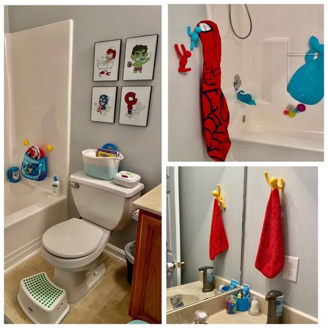 The picture displays a colorful superhero themed bathroom for kids. There are prints above the toilet, which depict cartoon superhero characters in a bathroom setting. The colorful wall climbing characters serve as towel and bathrobe holders. The room is cheerful, colorful, and fun. All items included in the pictures can be found via the Amazon influencer page linked above. Super Hero Bathroom Ideas, Avengers Bathroom Ideas, Spiderman Bathroom Ideas, Marvel Bathroom Ideas, Kids Bathroom Themes Boys, Boys Bathroom Ideas Kid, Superhero Bathroom Decor, Bathroom Hand Towel Ideas, Marvel Bathroom