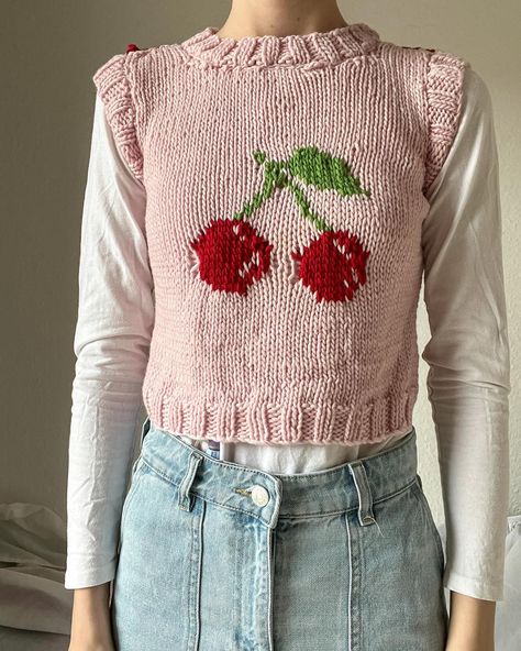 🍒 Cherry Sweater Vest🍒 I finally took some photos of this unblocked and burnt ✨ sweater vest I knitted. I made this shortly after my strawberry 🍓 sweater vest. When I tried steam blocking it, I accidentally burnt some of it (you may see the burnt fibre in the middle of the colourwork 🫣). I will say though, that this was really (!) fun to knit. I used some merino yarn 🧶 which was soooo soft 🥹 #knitting #fibreart #sweatervest #kitsch #cherry #cherrysweatervest #cottagecore Crochet Strawberry Vest, Strawberry Sweater Vest, Cherry Stuff, Strawberry Sweater, Cherry Sweater, Crochet Waistcoat, Knitted Stuff, Crochet Cat Hat, Crochet Strawberry