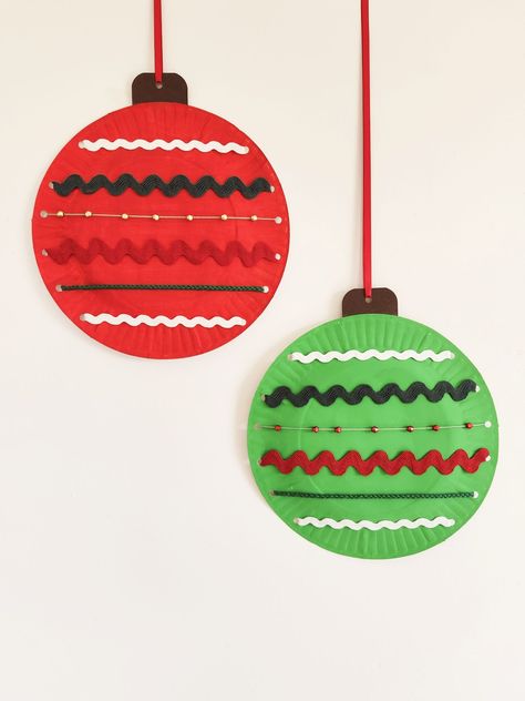 Looking for a fun craft to make with your kids this Christmas? Why not try making these fun paper plate Christmas baubles? All you need is a paper plate, some paint or markers, and a few fun things to decorate with. They are super easy to make and look great too! Art Activities For Kids Christmas, Ornaments Crafts For Preschool, Paper Ornament Crafts For Kids, Hanging Christmas Crafts For Kids, Christmas Wreaths Crafts For Kids, Christmas Felt Crafts For Kids, Paper Plate Ornaments, Christmas Crafts With Paper Plates, Christmas Crafts Paper Plates