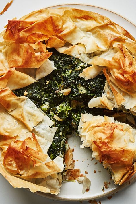 Often, spanakopita (a savory Greek spinach pie) is layered in a casserole dish or painstakingly formed into tiny perfect triangles. We’ve taken liberties with tradition and molded it into an open-face tart that requires much less intricate technique. The result is a “pie” with extra ruffly, crisp wisps of golden brown phyllo, forming a crown around the edges. Phyllo Dough, Spinach Recipes, Savory Pie, Spinach And Feta, Pastry Recipes, Dinner Tonight, Leeks, Pie Recipes, Bon Appetit