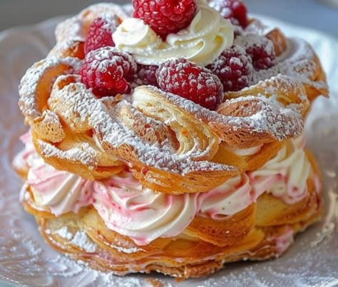 Ingredients:   1 cup water 1/2 cup unsalted butter 1/4 teaspoon salt 1 cup all-purpose flour 4 large eggs 1 cup heavy cream 2 tablespoons powdered sugar 1 teaspoon vanilla extract 1 cup fresh raspberries Additional powdered sugar for dusting Directions: Preheat the oven to 425°F (220°C). Line a baking sheet with parchment paper. In […] Raspberry Pastry Filling, Raspberry Pastry Cream, Pari Brest Recipe, Raspberry Danish Puff Pastries, Paris Brest Recipes, Raspberry And Cream Pastry, French Vanilla Pastry Cream, Raspberry Paris Brest, Puff Pastry Recipes Dessert