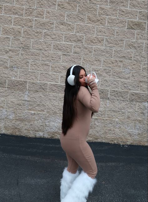 Fashion content creator wearing fashionnova jumpsuit paired with white furry boots and leg warmers. White ear muffs and long black hair. Fuzzy Bucket Hat Outfit Winter, White Ear Muffs Outfit, Ear Muffs Outfit Y2k, Fuzzy Earmuffs Outfit, Earmuffs Outfit Winter, Earmuff Outfits, Fuzzy Bucket Hat Outfit, Bucket Hat Outfit Winter, Ear Muffs Outfit