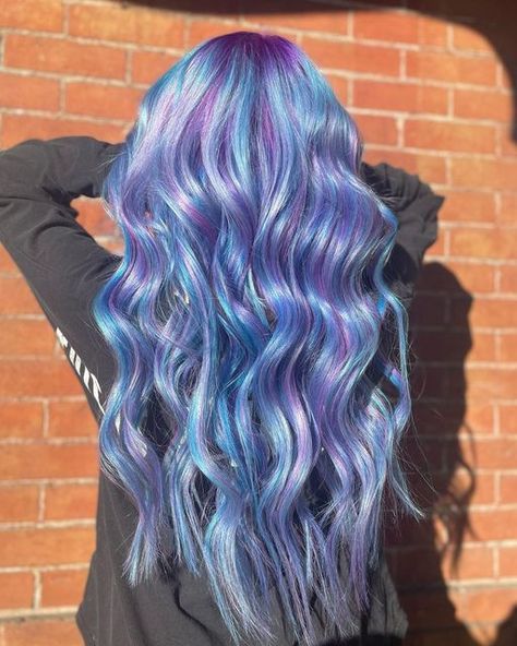 Pulp Riot Hair Color on Instagram: "@deathbycurler_ is the artist ❄️ #PulpRiotSemis are the paint. 🎨 Shades used: Lilac, Nevermore, and Powder, and Blue Muse Image Description: A photo of the back of a woman's head standing in front of a brick wall with her hands in her hair. She has long, purple and blue curled hair." Pulp Riot Hair Color, Curled Hair, Pulp Riot Hair, A Brick Wall, Pulp Riot, Boring Hair, Head Stand, Image Description, Dress Hairstyles