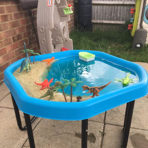 Sand, water (mixed with food dye) and dinos - what more could a dino mad child want?! Water Tray Ideas Eyfs, Sand Tray Ideas Eyfs, Summer Preschool Themes, Tuff Tray Ideas Toddlers, Kids Water Table, Tuff Tray Ideas, Beach Activity, Diy Kids Playground, Eyfs Activities