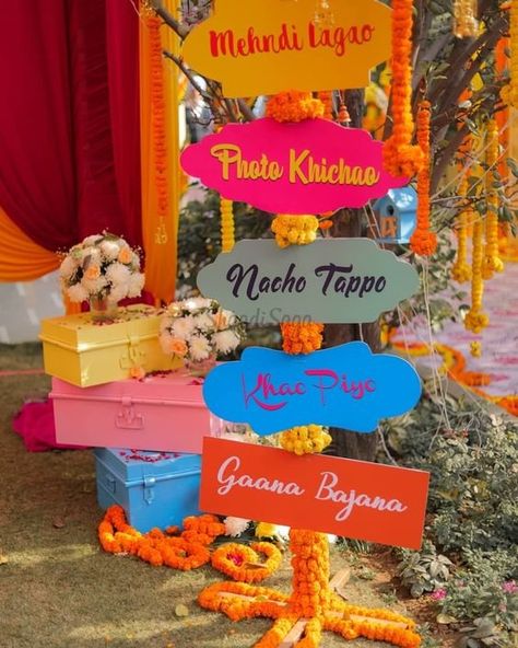 Quirky and fun Sign Board ideas for your wedding !  #indianwedding #shaadisaga #indianweddingdecor  #weddingdecorideas #weddingvenue #eventdesign #uniquedecor #diy #rustic #elegant #ceremony Haldi Decoration Ideas, Haldi Ceremony Decorations, डिजाइनर कपड़े, Mehendi Decor Ideas, Wedding Decor Photos, Wedding Entrance Decor, Desi Wedding Decor, Wedding Planning Decor, Beautiful Wedding Decorations