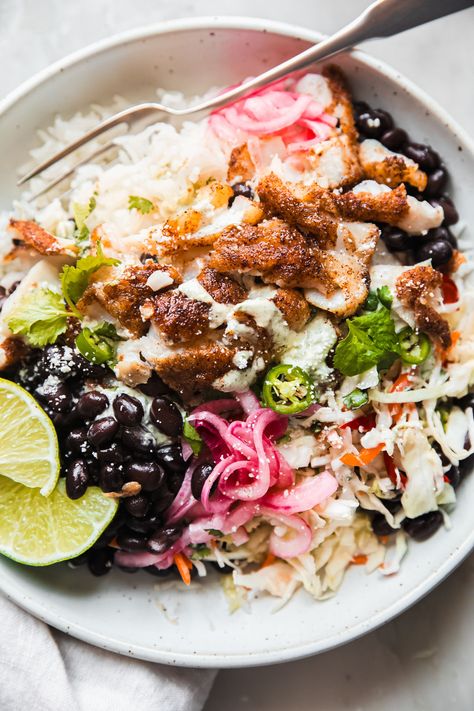 Fish Taco Bowls are everything you love about fish taco in a bowl! Seasoned fish, with pickled onions, beans, rice, sauce and cabbage slaw! Fish Taco Seasoning Tilapia, Taco In A Bowl, Fish Taco Bowl, Main Dish For Potluck, Rice Sauce, Chipotle Chicken Bowl, Spicy Fish Tacos, Taco Bowl Recipe, Fish Taco