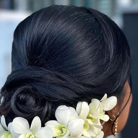 Annabel Bridal Hair & Makeup on Instagram: "A bridal updo that’s softly curled and collected in a romantic, swirl bun complemented with individually hand pinned white orchids 🤍🕊️ @khaavieniah_sathi was very unsure with how she would look in an updo. So I made sure to give her something very naturally face framing, loose and light 🌈" Swirl Bun, Flower Bun, Bridal Hair Makeup, Hand Pin, Tamil Wedding, Flower Arrangements Diy, Bridal Updo, White Orchids, Bridal Hair And Makeup