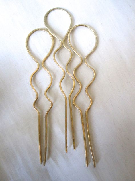 "A beautiful textured brass hairpin is hand shaped and forged into a sturdy and dependable accessory. Each piece is made slightly different, so your hairpin will be a one of a kind. These work great for thick or fine hair, curly or straight. Due to the nature of hammering the metal, this pin has integrity and will not loose it's shape through many uses. Measures about 7\" long. If you need shorter or longer, let me know and I can make it for you." Hairpin Bun, Brass Hair Pin, Diy Hair Accessories Ribbon, Handmade Hairpin, Bun Holder, Gold Hair Pin, Brass Pin, Hammered Brass, Casting Jewelry