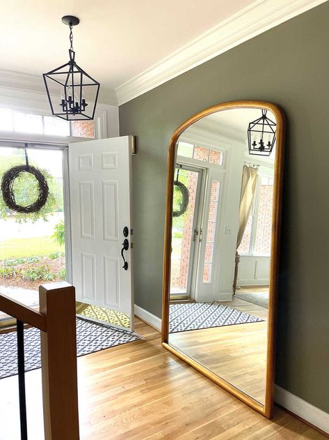 Foyer view with front door open, walls painted Sherwin Willams adaptive shade and floor leaner mirror Sherwin Williams Adaptive Shade, Olive Green Home Decor, Green Home Decor Ideas, Green Living Room Paint, Olive Green Rooms, Sherwin Williams Paint Colors Green, Olive Living Rooms, Simple Entryway, Olive Bedroom