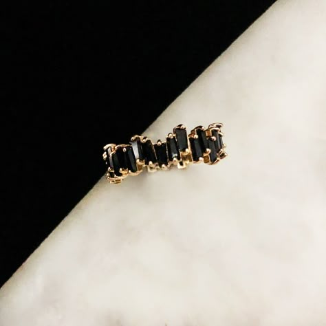 Our Dark Halo Ring is tapered baguette jet stones unevenly set next to each other forming a modern eternity band with a darker side. Brass plated in goldtone. All stones are black cubic zirconia. All orders over $50 ship for free within the USA. All orders usually ship within 24 hours from the USA. Black Stacking Rings, Black Jewelry Aesthetic, Modern Eternity Band, Mama Outfits, Dark Rings, Hand Candy, Jet Stone, Aesthetic Rings, Ring Game