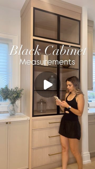 Laura Rustico II Building Beauty Full on Instagram: "Giving the details on our black framed kitchen cabinets here 👇   First off, let me start by saying our kitchen company nailed it! I came to them with the idea of these cabinets and they executed perfectly!   We have two cabinets in the kitchen that mirror one another. They sit as the end pieces of our kitchen which really complete the look and feel of the space.   Here are the specs / dimensions:✨✨  📏10ft high x 4ft wide 🎨Stain- Zar Beach House 🪵Rift Sawn White Oak Material  ▪️Aluminum Black Frame. 4 doors total.  ⚜️Push latch  @topknobs Hardware - linked in my bio. Or comment “HARDWARE” for a link.   #organicmodern #ontariomoms #intentionaldesign #newhomeconstruction #homediy #canadianhome #customhomedesign #topknobs" Kitchen Range Hood Ideas Modern, White Oak Kitchen With Black Accents, Rift Sawn White Oak Cabinets Stain, Cabinet On Countertop, Oak And Black Kitchen, Black Stained Kitchen Cabinets, Topknobs Hardware, Flat Kitchen Cabinet Doors, Black Glass Cabinet