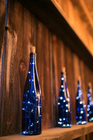 Blue wine bottles with Christmas lights | Winery wedding decor ideas Gold Celestial Wedding, Starry Night Wedding Theme, Midnight Blue Wedding, Star Themed Wedding, Celestial Wedding Theme, Virginia Winery Wedding, Starry Wedding, Galaxy Wedding, Starry Night Wedding