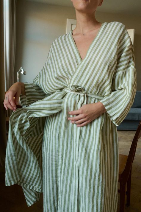 Linen robe designed for lounging routines. In full length, ¾ length dropped sleeves, and side seam pockets. Features a classic V-neck, and separate belt to delicately hug the body. This robe is crafted from natural and lightweight linen to ensure a breathable and soft experience. Cut in a relaxed shape, perfect to snuggle up with a morning coffee. SIZING AND FIT This garment is oversized. If you want to wear this piece as close-fitting, select a smaller size than you usually wear. Before placing Linen Bathrobe, Linen Robe, Linen Shop, Womens Robes, Striped Linen, Lithuania, Clothing Patterns, Morning Coffee, Full Length