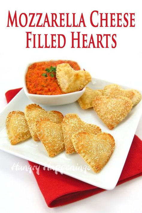 30 minutes · Serves 12 · Serve these heart-shaped appetizers for Valentine's Day, on a special date night, or at a bridal shower. Each pie crust heart is filled with Mozzarella Cheese and is served with roasted red pepper… More Heart Shaped Grilled Cheese, Finger Food Valentines Day, Savoury Valentines Snacks, Valentine’s Day Savory Appetizers, Savory Valentines Day Snacks, Valentines Treats Savory, Valentine’s Day Food Savory, Savory Valentine Treats, Easy Valentines Appetizers