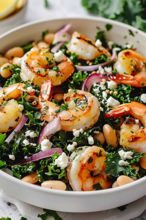 Close-up of a hearty Kale and White Bean Salad, An Erewhon Copycat Recipe featuring succulent shrimp, onion slices, and a sprinkle of feta cheese, dressed in a zesty vinaigrette. Shrimp Kale, Kale White Bean, Kale And White Bean, Easy Shrimp Recipes, Easy Summer Recipes, Salad With Shrimp, Shrimp And Quinoa, Greek Chickpea Salad, Light Summer Meals