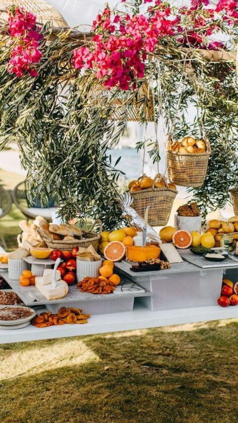 A beautiful wedding grazing table filled with clusters of different foods like cheeses, nuts, olives, breads, fruits and chacuterie. Wedding Grazing Table, Greenery Installation, Anti Pasta, Event Concept, Rattan Pendant Lights, Edgy Bridal, Wedding Food Stations, Appetizers Table, Fruit Centerpieces