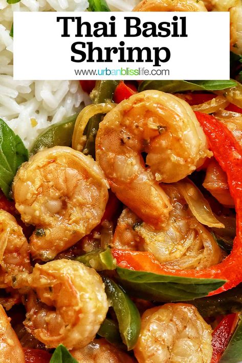 This Thai Basil Shrimp recipe is a popular Thai street food that is easy to make at home in under 30 minutes! Perfect weeknight dinner with rice. Get the easy Thai recipe at UrbanBlissLife.com. Thai Basil Salmon, Thai Shrimp Recipes, Thai Basil Sauce, Thai Basil Shrimp, Thailand Recipes, Polynesian Dishes, Dinner With Rice, Thai Basil Recipes, Thai Recipes Dessert