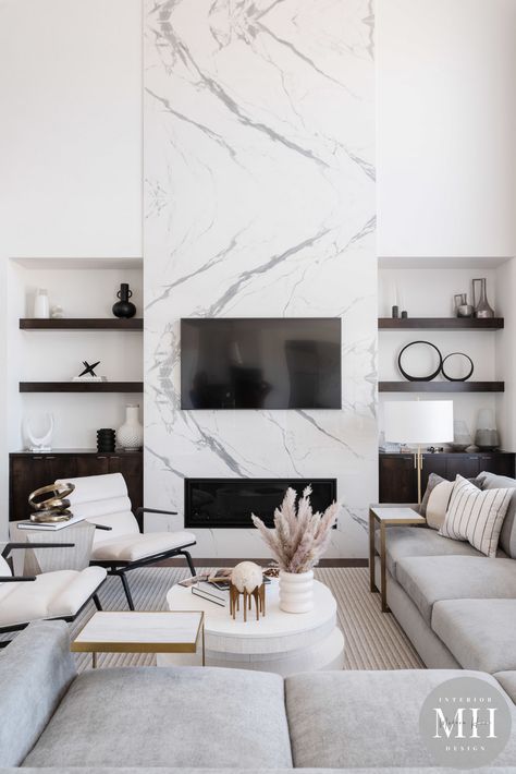 This living room is absolutely gorgeous! We love how timeless this space is! 🤍⏱ #styledbymh #omahainteriordesign #MHstyleathome #interiordesign #omaha #nebraska #omahanebraska #homedesign #homereno #livingroom #classicmodern #timeless #whitedesign #marble #fireplace #livingspace #home Modern Fireplace Ideas Living Rooms, Fireplace Modern Design, Marble Fireplace, Living Room Decor Fireplace, Omaha Nebraska, Home Fireplace, Modern Fireplace, Living Room Tv Wall, Interior Design Firm