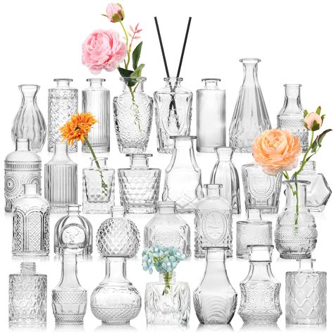 PRICES MAY VARY. STURDY AND THICK GLASS---30 pcs bulk bud vases are made of high quality thick and strong glass,which are durable and not easy to break. The bottom is non-slip and the center of gravity is stable. These petite little vases were perfect for wedding tables and also be reused for any other table decor or home decor. You can also add some dried flowers or aromatherapy sticks to the vase. ALL UNIQUE DESIGNS AND DIFFERENT SHAPES AND SIZES---The biggest feature of these 30 small bud vas Vases On Wedding Tables, Bridal Shower Centerpieces Flowers Simple, Pitchers With Flowers Centerpieces, Craft Table Wedding, Bridal Shower Table Center, Painted Vase Wedding Centerpieces, Mini Dried Flower Vases, Dried Flower Bud Vase Centerpiece, Small Table Floral Centerpiece