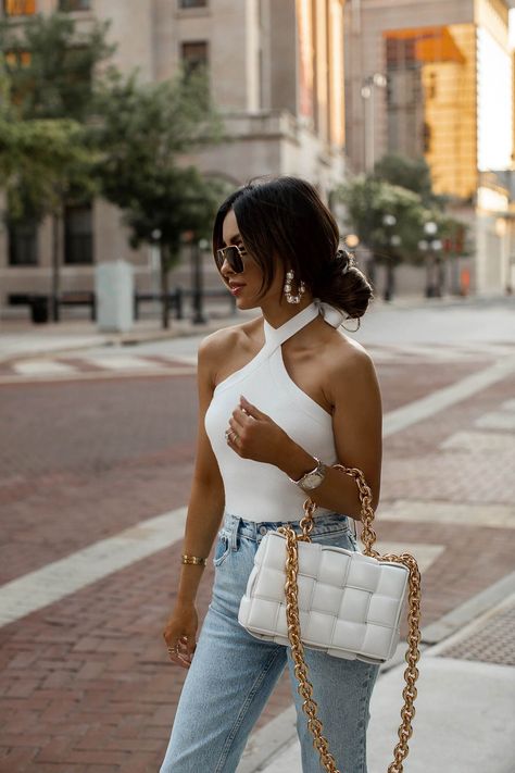 fashion blogger wearing a white halter top from abercrombie. bodysuits are the easiest way to style a chic summer outfit. all you need are a pair of statement earrings and high-waisted jeans and you're all set for a cute going out look. #summer #outfits #womensfashion White Halter Bodysuit, Bottega Veneta Chain Cassette, Halter Tops Outfit, Mia Mia Mine, Mia Mia, White Halter Top, Body Suit Outfits, Instagram Outfits, Looks Chic