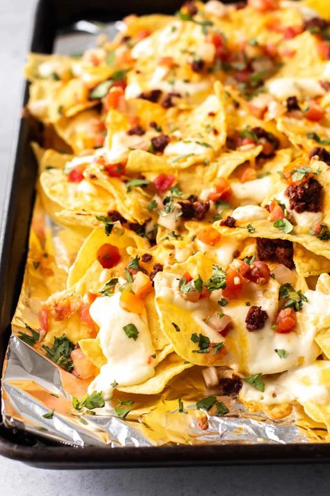 Warm tortilla chips layered with chorizo, creamy cheese sauce, pico de gallo, and cilantro! These Chorizo Nachos are perfect for game day, parties, or any time you're craving a big plate of homemade nachos. Chorizo Nachos, Chorizo Recipes Dinner, Shrimp Appetizers Easy, Creamy Cheese Sauce, Homemade Nachos, Mexican Chorizo, Chorizo Recipes, Quick Chicken Recipes, Meat Appetizers