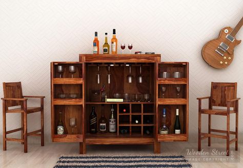 A stunning #barcabinet which is traditional and inspired by old design would fit your dining space keeping the look of the house intact.Made from pure #solidwoodfurniture and crowned with #honeyfinish perfect for dining room.  #diningroomfurniture #barcabinet #homefurniture  See it yourself: https://www.woodenstreet.com/toby-bar-cabinet-teak-finish Home Bar Cabinet, Wooden Street, Old Design, Bar Cabinet, Solid Wood Furniture, Dining Space, Styling Tips, Bars For Home, Bar Furniture