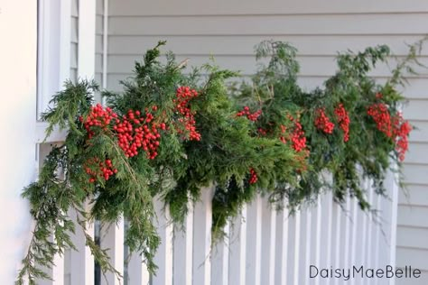 Porch Railing Decorations Christmas, Christmas Porch Railing Decor, Split Level Christmas Decor Outdoor, Outdoor Railing Christmas Decorations, Christmas Porch Railing Decorating Ideas, Front Porch Railing Christmas Decor, Outdoor Garland Christmas Porches, Porch Railing Christmas Decor, Front Porch Christmas Ideas