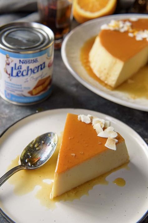 You don't have to be on a tropical vacation to enjoy a slice of this silky-smooth Orange Coconut Flan - it's just as easy to make at home! A tasty variation on the classic, this flan de coco combines a creamy coconut custard with an orange-rum caramel crown. #crumbykitchen #flan #flandecoco #coconutflan #hispanic #dessertrecipes Portuguese Flan Recipe, Coconut Pastries, Coconut Milk Flan, Coconut Flan Recipe, Flan Recipes, Fruit Flan, Rum Caramel, Pumpkin Flan, Coconut Flan