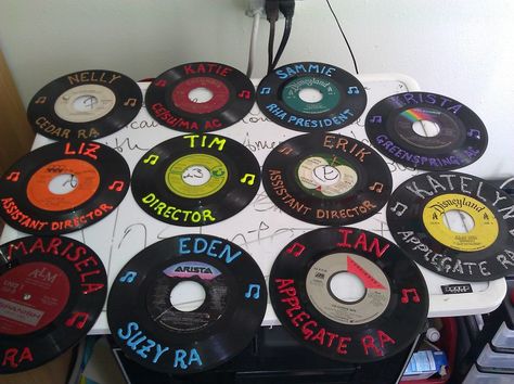 Reuse records or make your own.  Have the record match someone's favorite song or pick a song that could be the resident's theme song. Dorm Door Name Signs, Dorm Name Signs Door Decs, Disco Door Decoration, Dorm Door Decorations College Ra, Doortags Ra, Dorm Hall Themes, College Door Decs, Dorm Name Tags, College Decorations