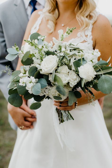 Greenery and White Bouquet with Eucalyptus   #tallcenterpiece #greenerycenterpiece #weddingcenterpiece #greenerywedding #floralcenterpiece #italianruscus #roses #blushwedding #fallwedding #summerwedding #winterwedding #weddingfloral #texturedbouquet #peonyweddingbouquet #handtiedbouquet Bouquet With Eucalyptus, East Lansing Michigan, Eucalyptus Wedding Bouquet, White Rose Wedding Bouquet, Greenery Wedding Bouquet, Rustic Glam Wedding, Church Wedding Flowers, Floral Design Wedding, White Rose Bouquet