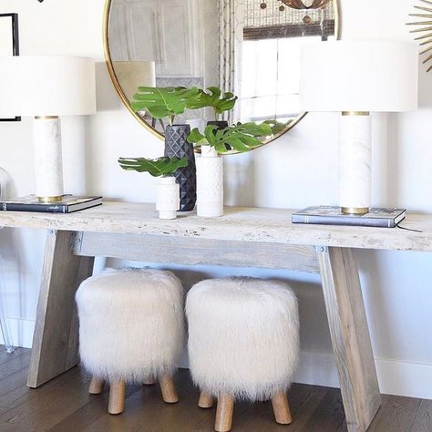 5,950 Likes, 27 Comments - Pottery Barn (@potterybarn) on Instagram: “We spy our Mongolian Faux Fur Stool so perfectly tucked under a console in the entry of…” Fur Stool, Rustic Console, Round Gold Mirror, Grey Wood Floors, Rustic Console Tables, Foyer Decorating, Gold Mirror, Remodel Ideas, Rustic Home Decor