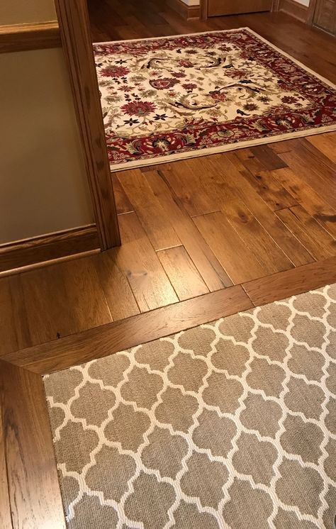 Entry rug on wood floor & carpet inlaid under a wood border in next room. Love the various sized wood planks! Carpet With Wood Floor Border, Wood Floor With Carpet Inlay, Rugs On Wood Floors, Carpet Inlay, Wood Flooring Ideas, Staining Wood Floors, Best Wood Flooring, Types Of Wood Flooring, Reclaimed Wood Floors