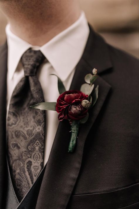 A dark burgundy boutonnière for the groom gave a touch of color to his black suit on his wedding day. To see more florals from their wedding day, click link to go to their wedding day blog post. Fall Boutonniere Burgundy, Dark And Moody Wedding Boutonniere, Dark Wedding Boutonniere, Dark Red Bouquet Wedding, Dark Boutonniere, Groomsman Flowers, Moody Boutonniere, Dark Burgundy Wedding, Burgundy Groomsmen