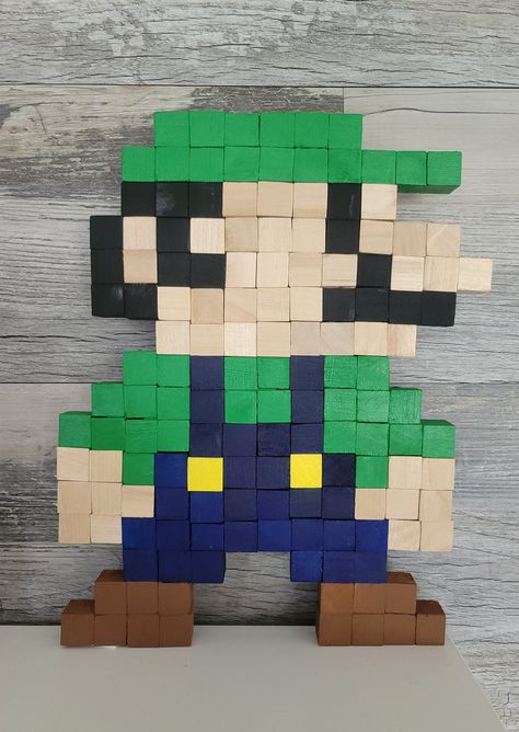 Cube Blocks Ideas, Mario And Luigi Decorations, Luigi Decorations, Wooden Pixel Art, Luigi Perler Bead Patterns, Diy Mario Wall Decor, Perler Bead Luigi, Luigi Cross Stitch, Mario Bro Wall Art